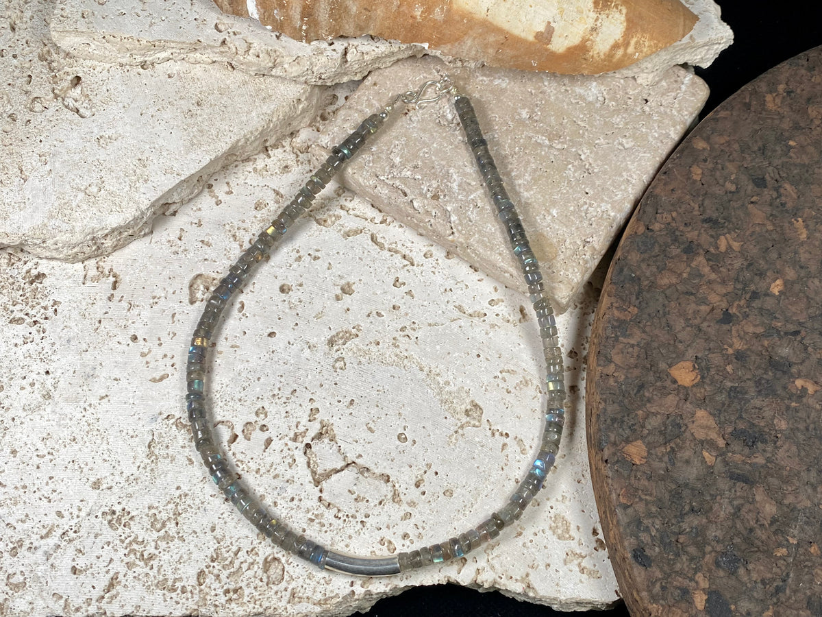Striking choker necklace of rondel-cut labradorite, highlighted with a central sterling silver pendant bead. This necklace is finished with a sterling silver hook clasp. Length 42 cm