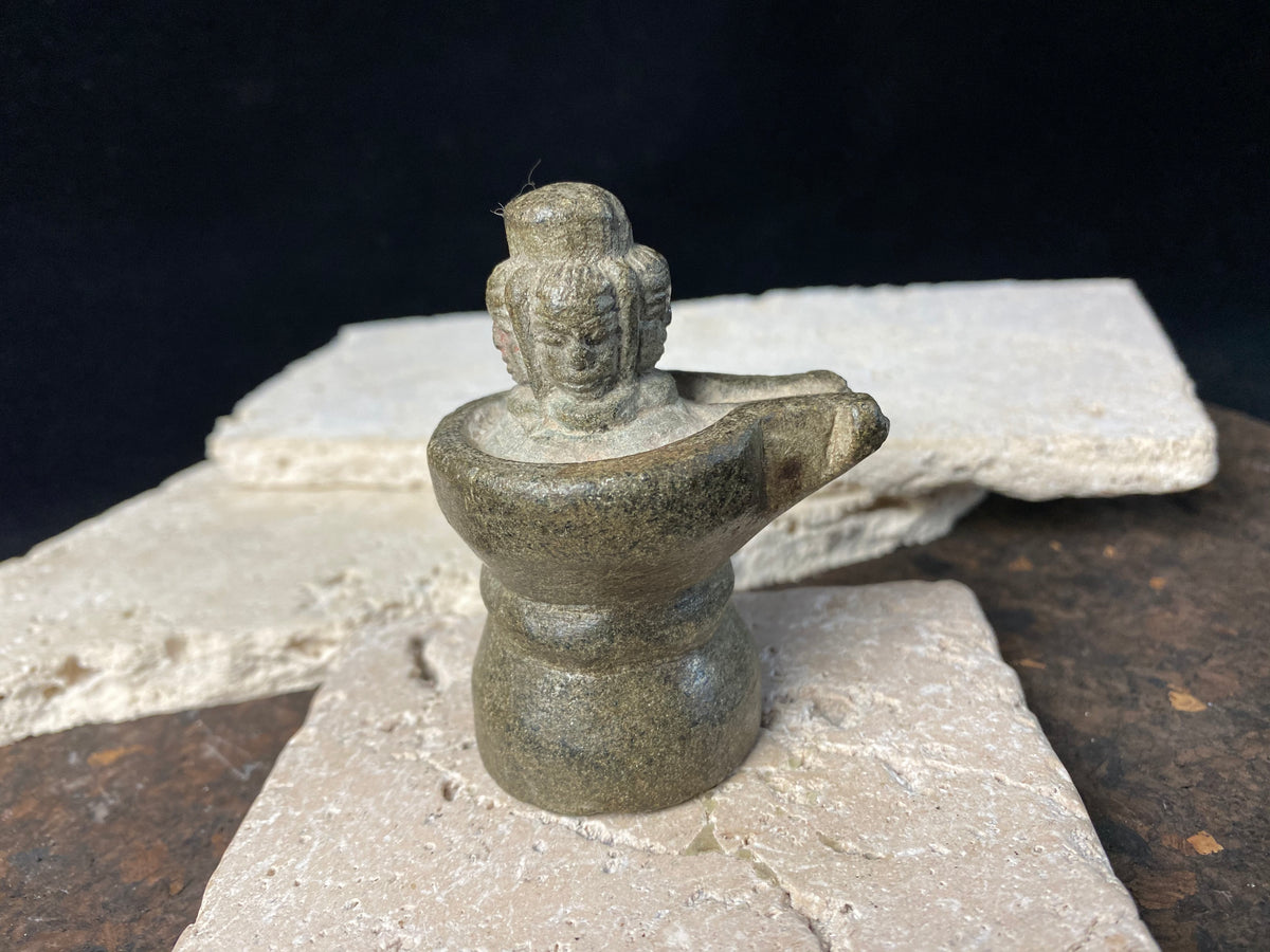 Shiva lighan of the type used in private homes, dating from the early 20th century, hand carved from serpentine, features 4 Shiva heads facing the cardinal points