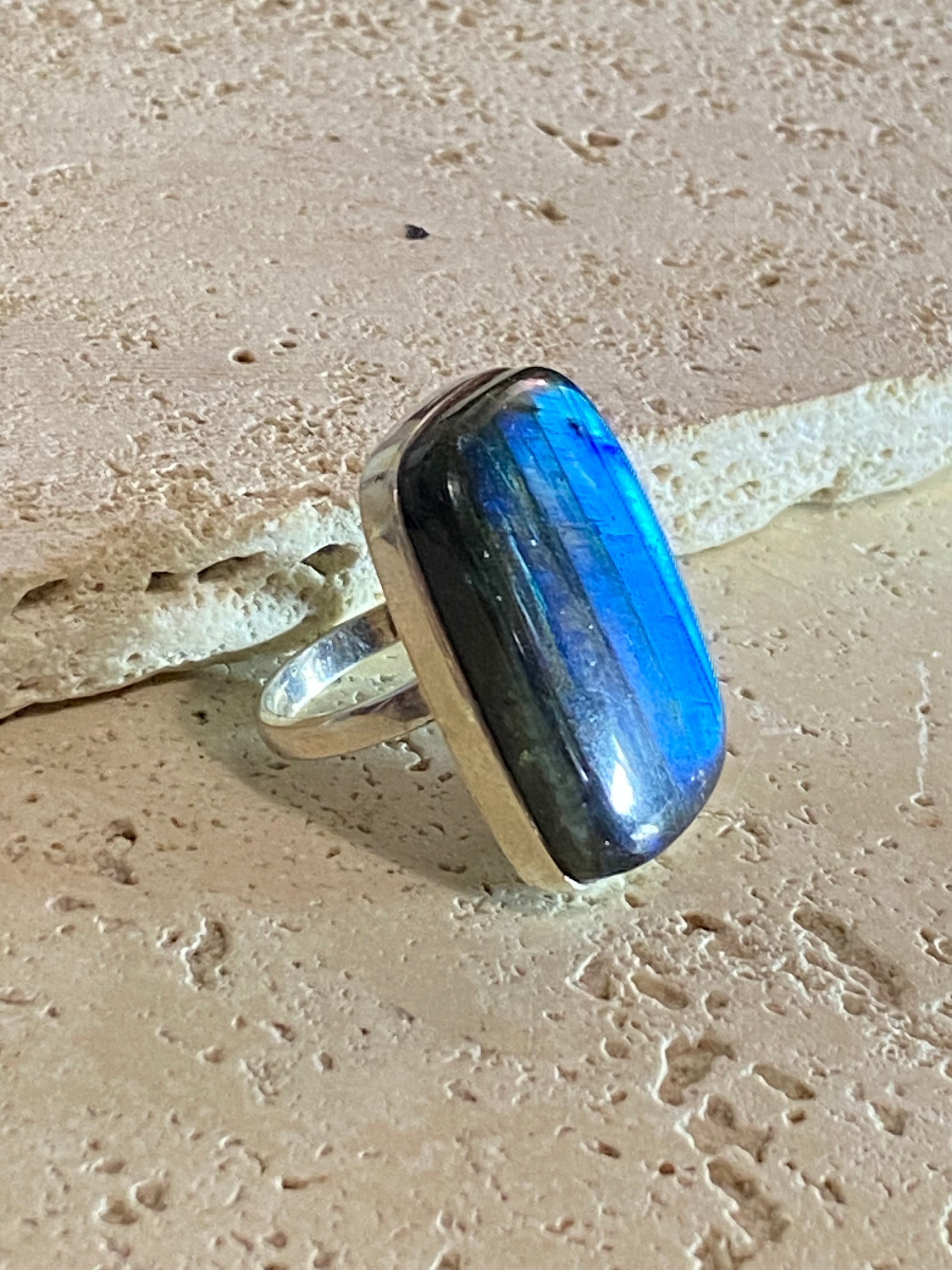 Stunning large rectangular cut labradorite ring set in heavy sterling silver. A high quality stone with a unique striating pattern and excellent colour.  Size 8