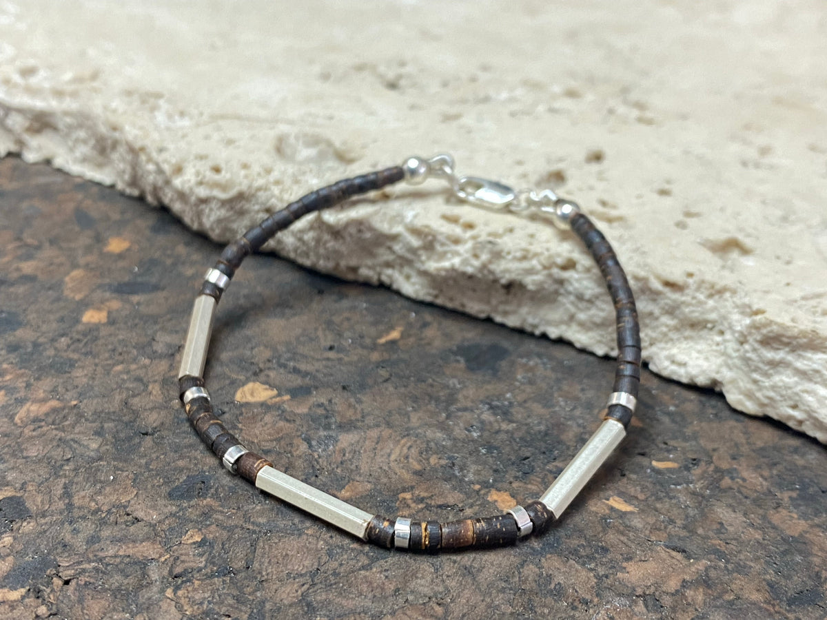 One of our signature coconut silver bracelets, crafted from polished coconut wood and hill tribe 95% silver., with sterling silver lobster clasp. A women's bracelet or a men's bracelet, it has a casual Boho vibe, and is made for that stacked bracelet look. Different sizes available