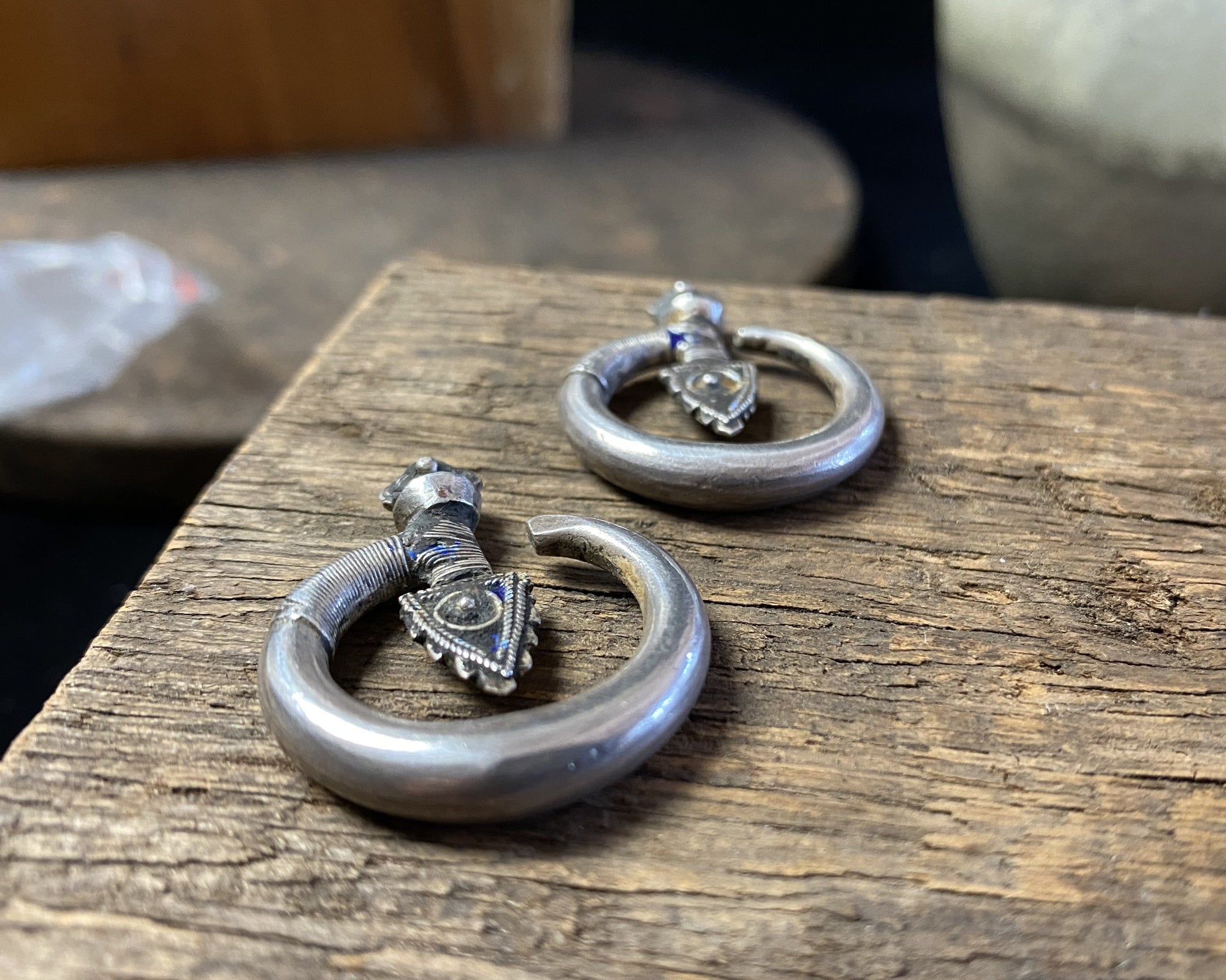 Tribal silver earrings called Bent Arrow. Worn pushed sideways through the ear by Yao women. High grade silver, they can only be worn with an extended piercing