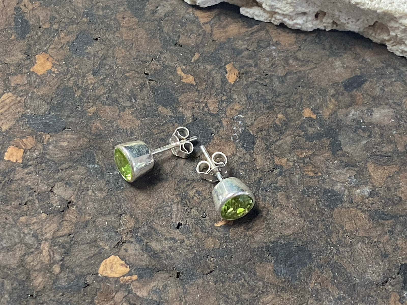 Elegant facet cut peridot and sterling silver earring studs, diameter 7 mm height 5 mm