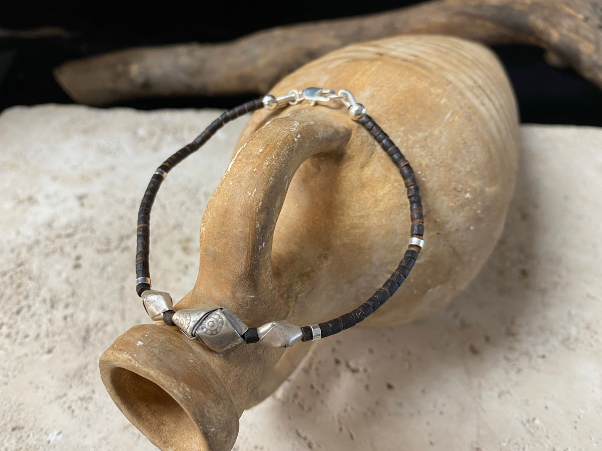 One of our signature coconut silver bracelets, crafted from polished coconut wood and hill tribe 95% silver., with sterling silver lobster clasp. A women's bracelet or a men's bracelet, it has a casual Boho vibe, and is made for that stacked bracelet look. Different sizes available