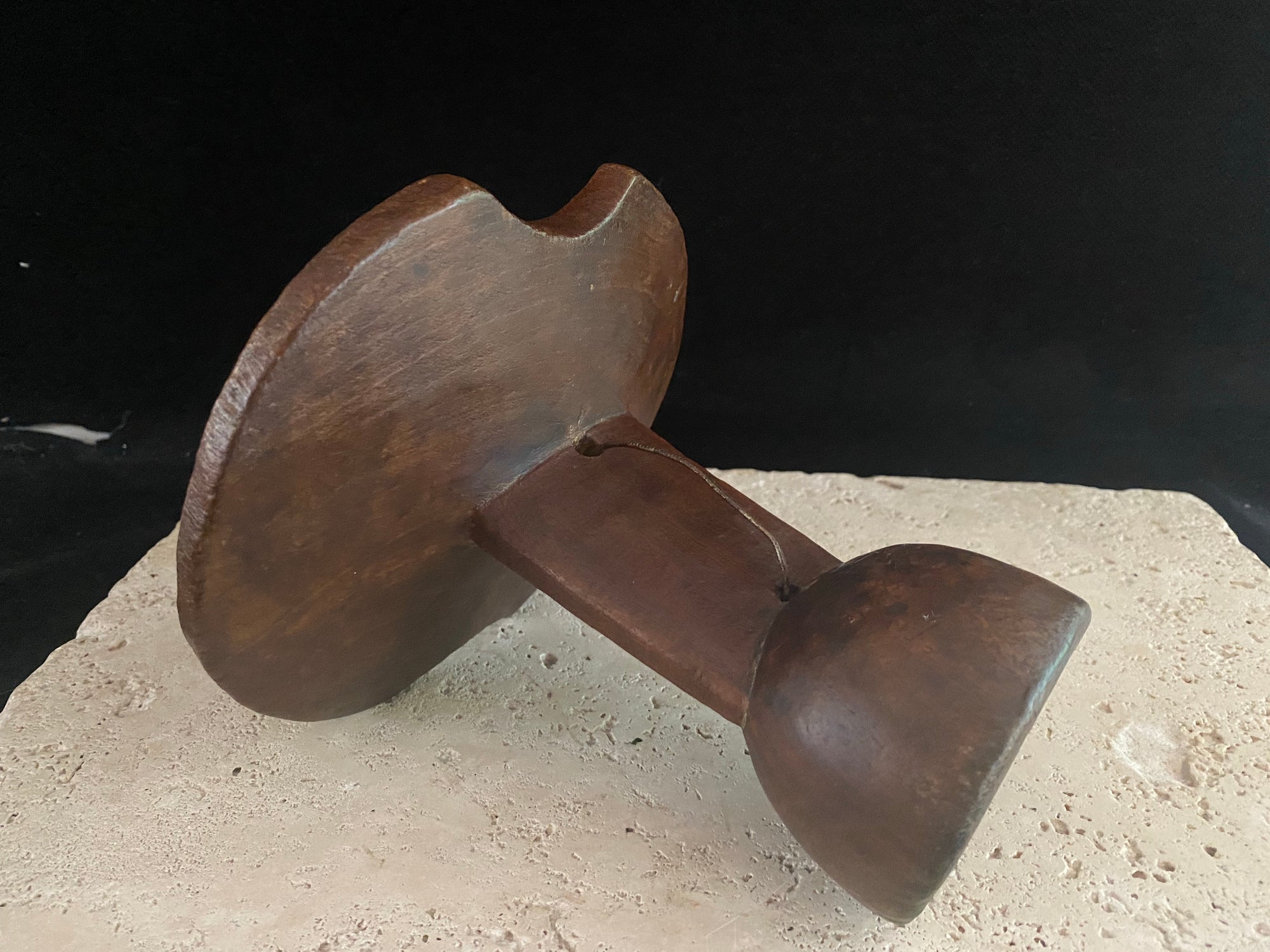 Mursi wood headrest, southern Ethiopia.   Carved from a single piece of wood, with cutouts. Vintage, late 20th century, with patina and wear appropriate to its age. A wire handle is attached. 15 cm height