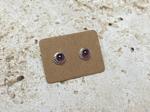 These small garnet studs are hand made from sterling silver and set with natural garnet cabochon stones