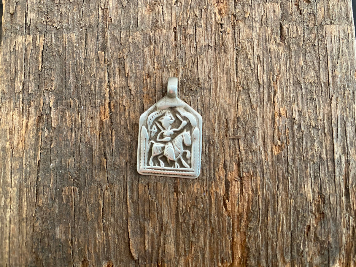 Antique silver amulets that represent Baba Ramdev (Ramdevshi), a legendary Rajput warrior who went about doing deeds of goodness and valour. These small pendants are traditionally worn for protection and good luck and date from the early 19th - early 20th century.  Measurements: all vary between 1.5 and 1.7 cm in width