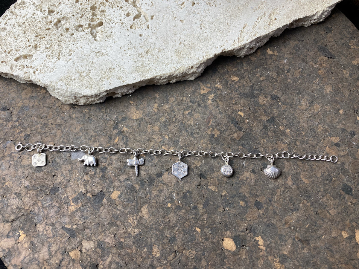 Sterling silver charm bracelet with 6 charms including elephant, dragonfly and seashell, with plenty of room to add more charms. With extension chain