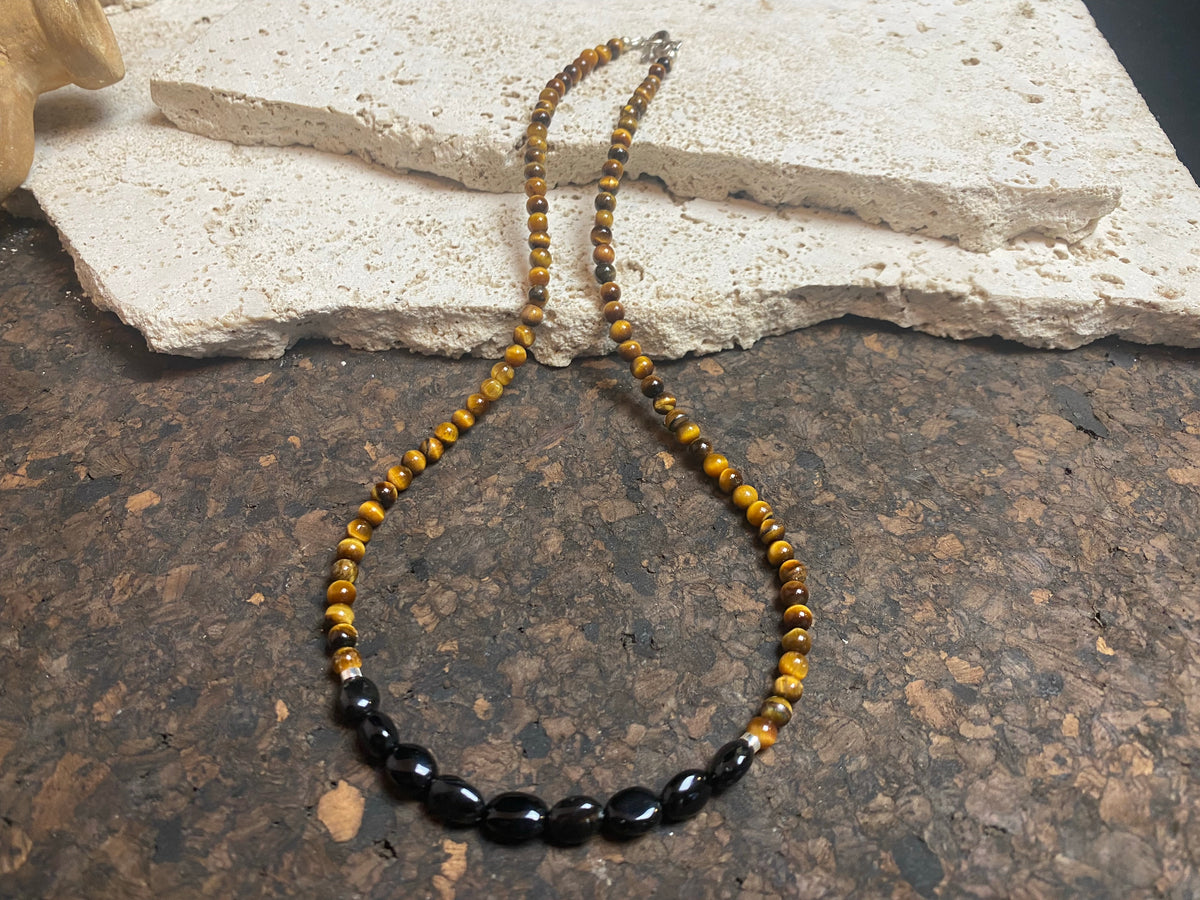 Earthy, rich and natural - our natural tigers eye necklace features pebble cut black agate and sterling silver detailing. This boho necklace is ethnic inspired chic. Length 46.5 cm