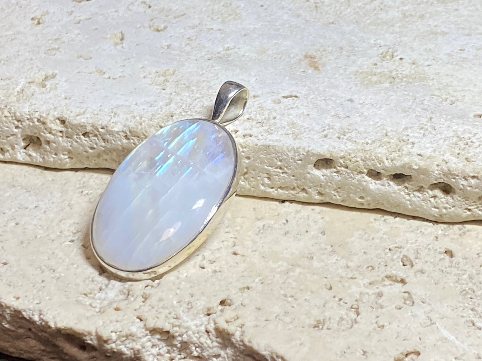 Large oval rainbow moonstone pendant set in sterling silver with a generous bail to take a large chain or cord. A beautiful stone with light blue, green and orange colour. 