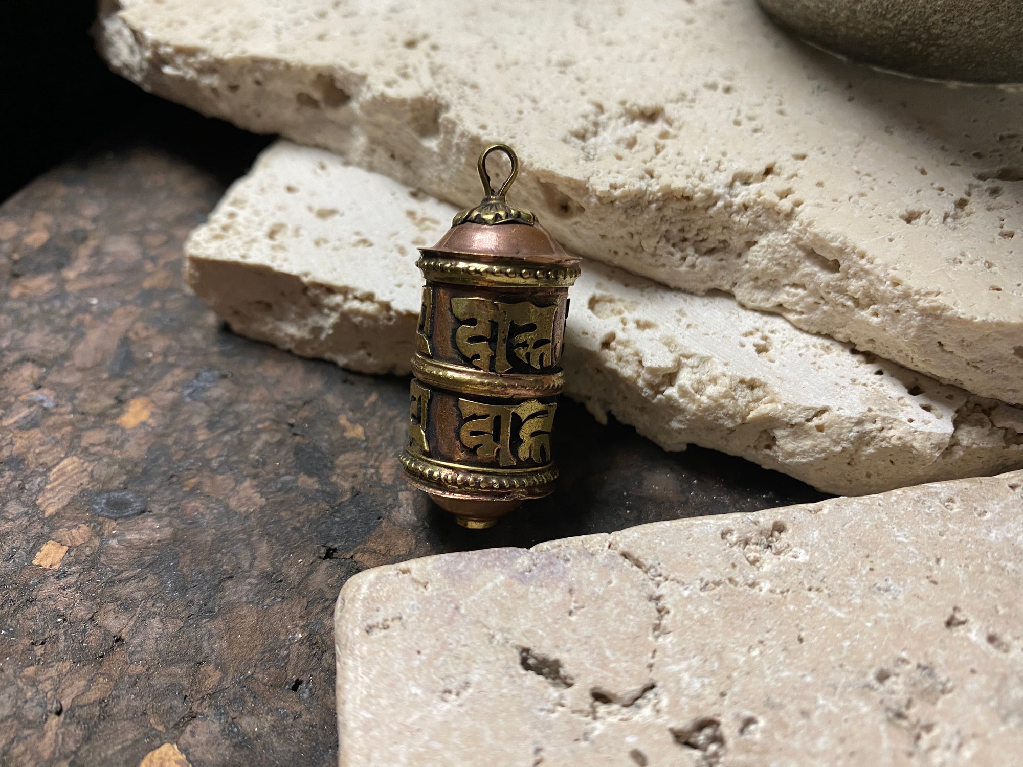 These copper and brass prayer boxes or amulets are designed to be worn as a pendant, or added to a keyring. Contains a prayer scroll withthe mantra to the Compassionate Buddha Om Mani Padme Hum , 4.5 cm length