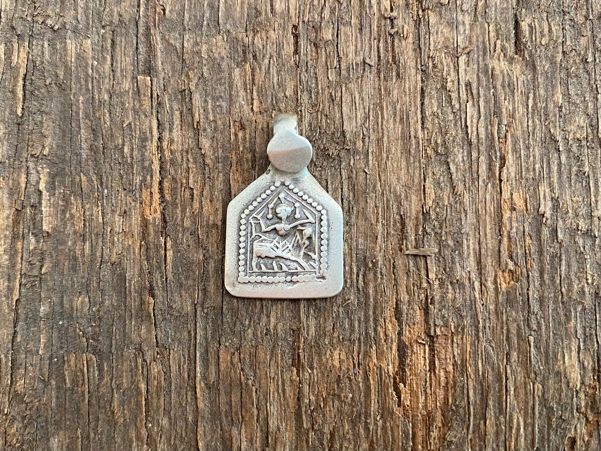 Antique silver amulets that represent Baba Ramdev (Ramdevshi), a legendary Rajput warrior who went about doing deeds of goodness and valour. These small pendants are traditionally worn for protection and good luck and date from the early 19th - early 20th century.  Measurements: all vary between 1.5 and 1.7 cm in width