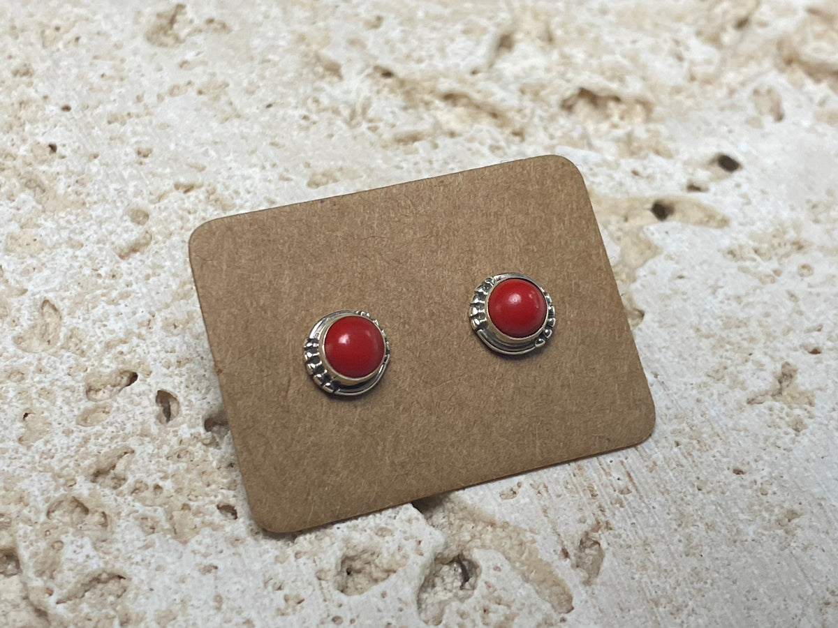 Simple and elegant, these small red coral earring studs are hand made from sterling silver and set with bamboo coral cabochons