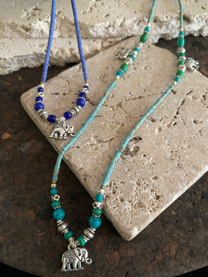 Beaded stone elephant necklace in either turquoise or lapis blue, each featuring three small elephant charms. This beautiful stone necklace is indistinguishable from much more expensive sterling silver and natural turquoise or lapis necklaces. This is unisex jewellery that can be worn either as a bracelet or as a necklace
