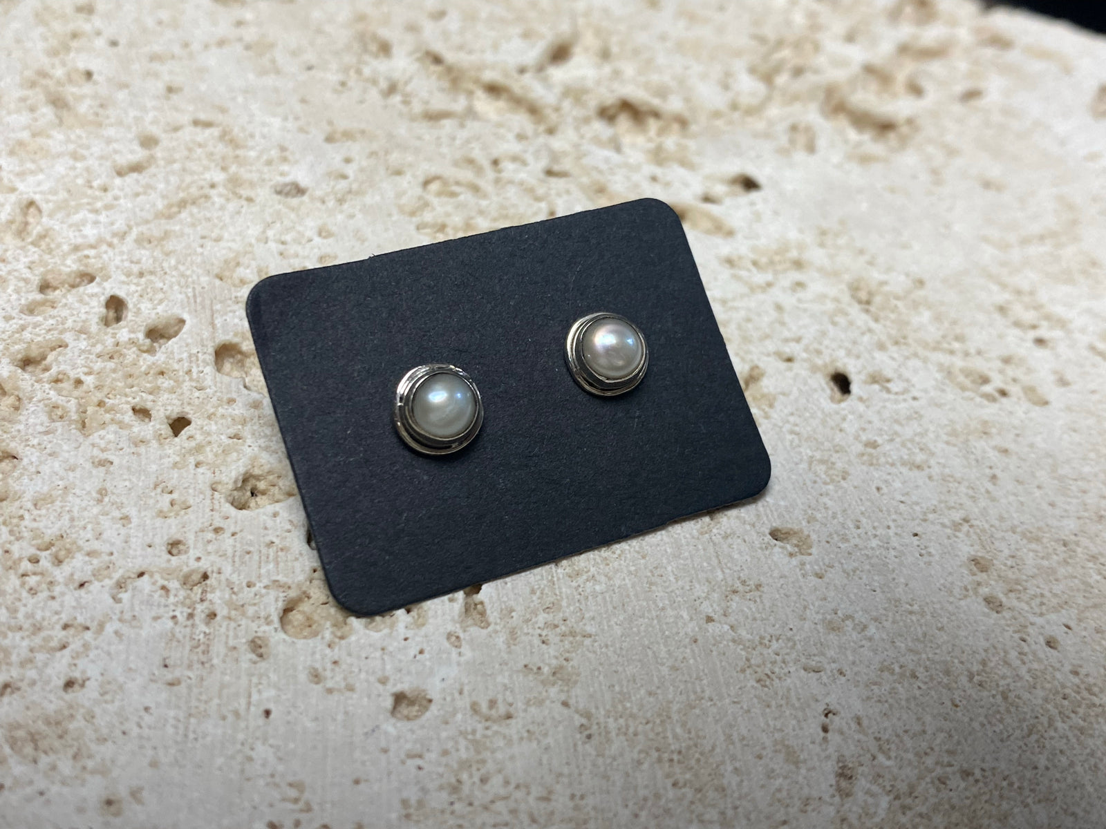 These small pearl studs are hand made from sterling silver and set with natural pearl cabochon stones