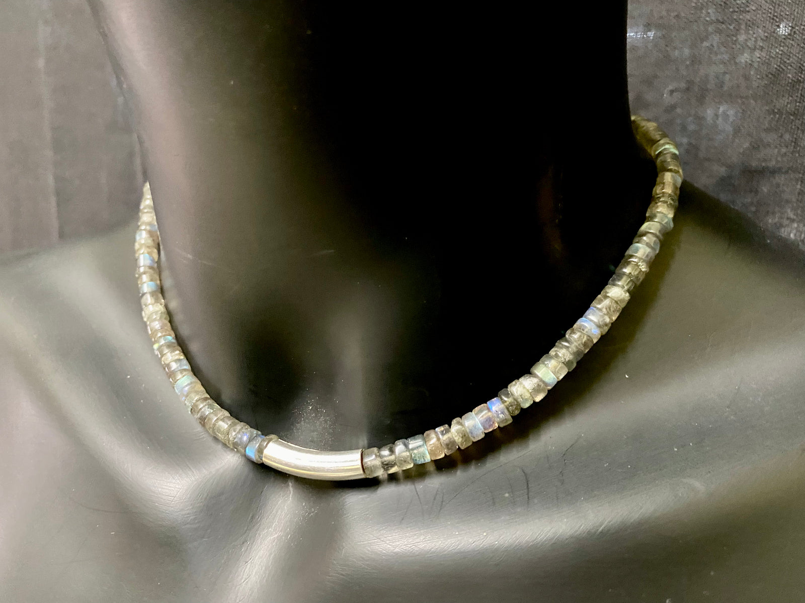 Striking choker necklace of rondel-cut labradorite, highlighted with a central sterling silver pendant bead. This necklace is finished with a sterling silver hook clasp. Length 42 cm