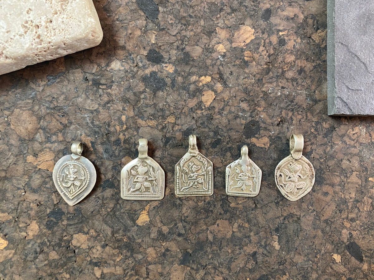 Antique silver amulets representing the Hindu god Hanuman, traditionally worn for protection and good luck. Originating in southern India, and dating from the early 19th - early 20th century.  All vary between 1.4 and 1.7 cm in width