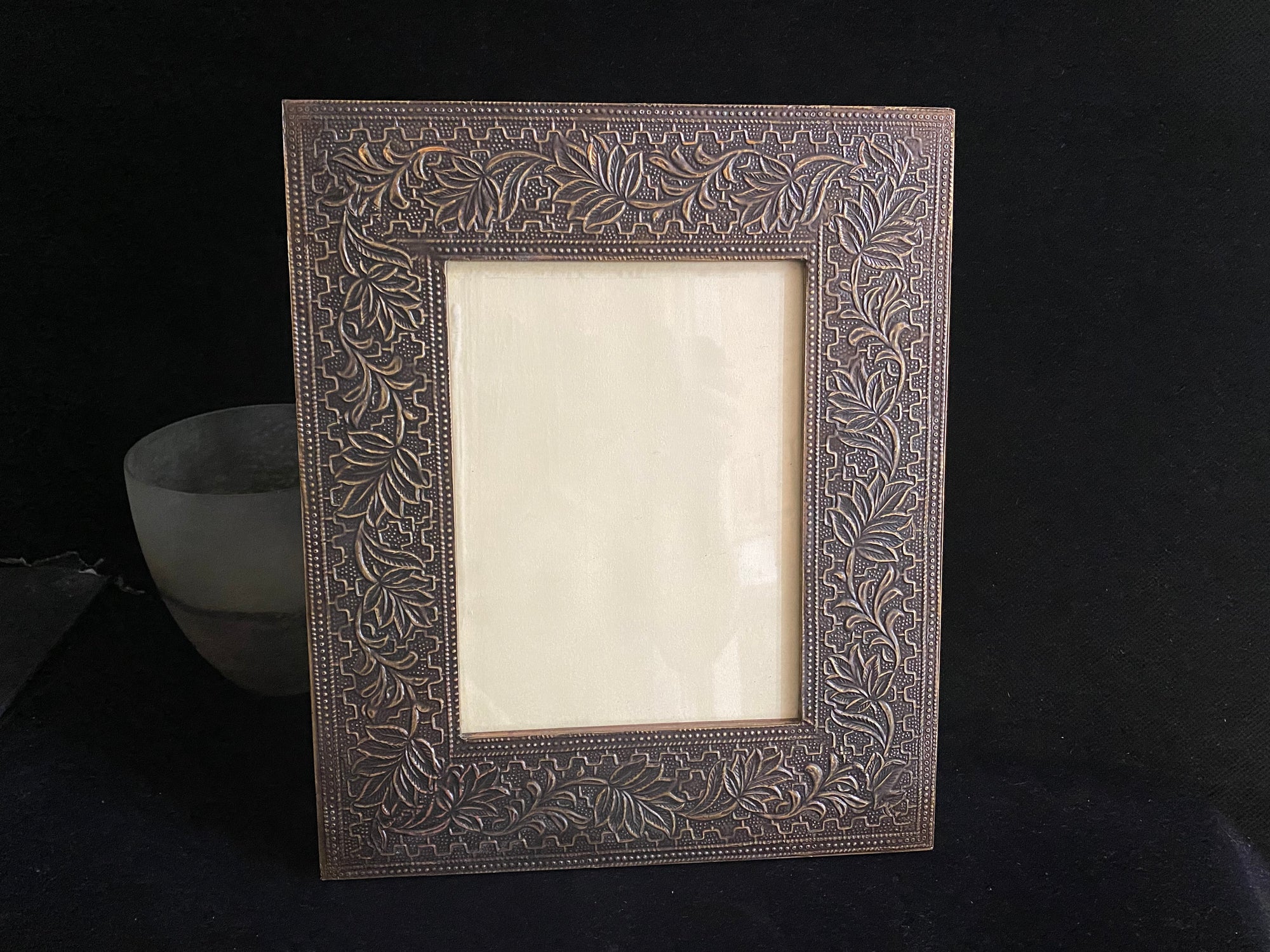 Photo frame features patterned brass over a hardwood frame