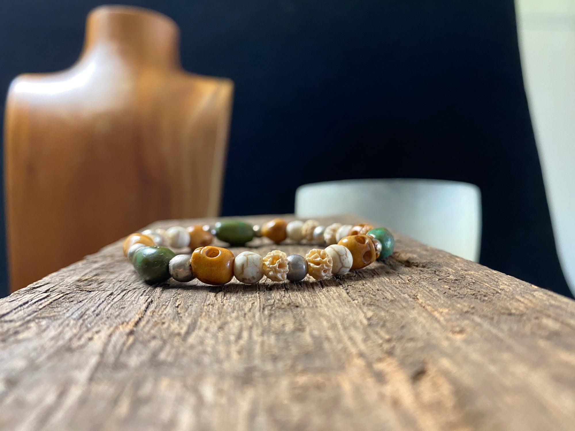 Stretchy bracelet featuring hand carved yak bone skulls, natural antique Tibetan turquoise, undyed howlite , carved lotus root and sterling silver beads. Designed to fit on a wrist 11-14 cm circumference 