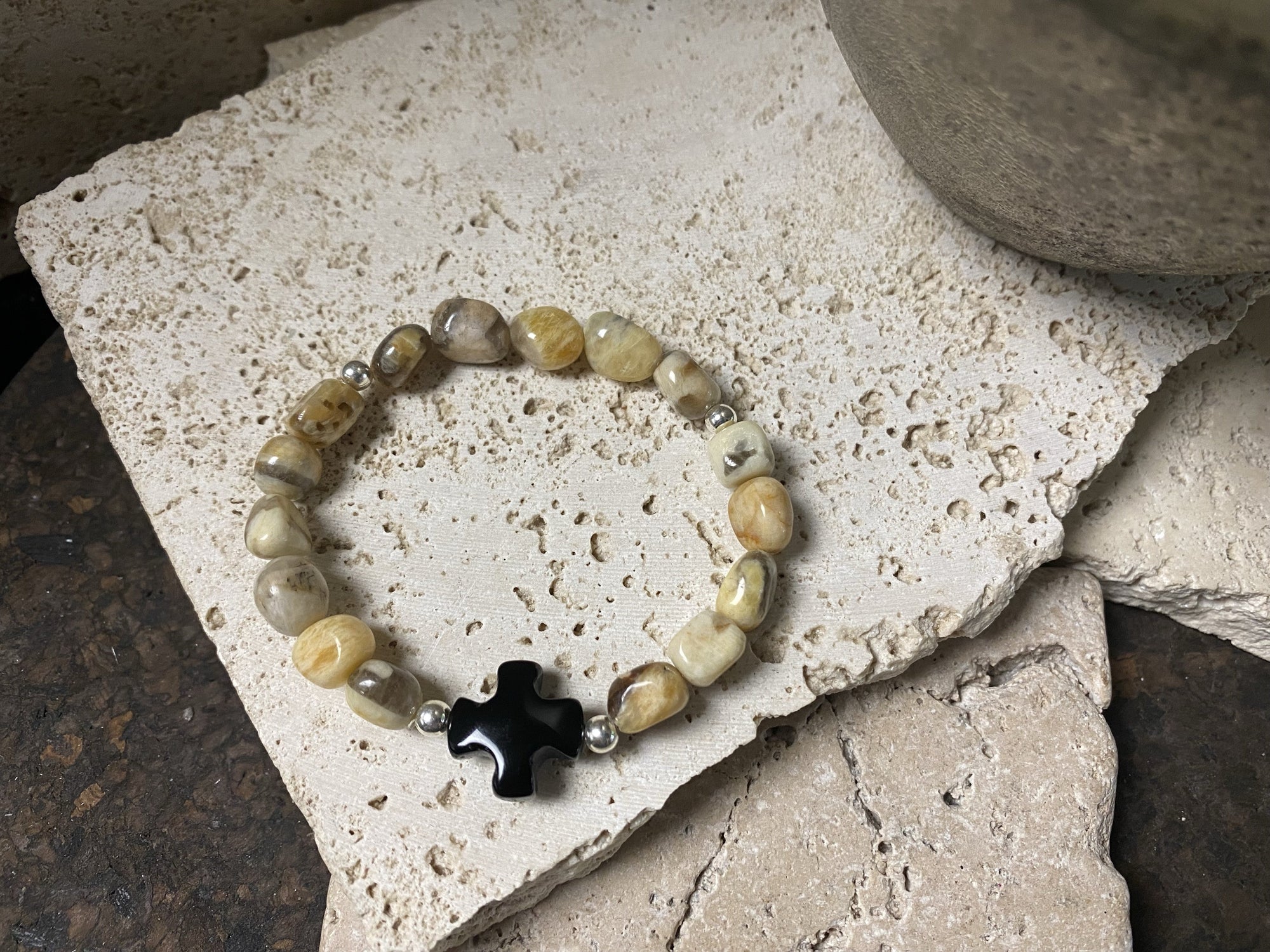 Natural zebradorite boulder stones are teamed with an organic black agate cross pendant and sterling silver detailing. Wrist diameter 15 cm