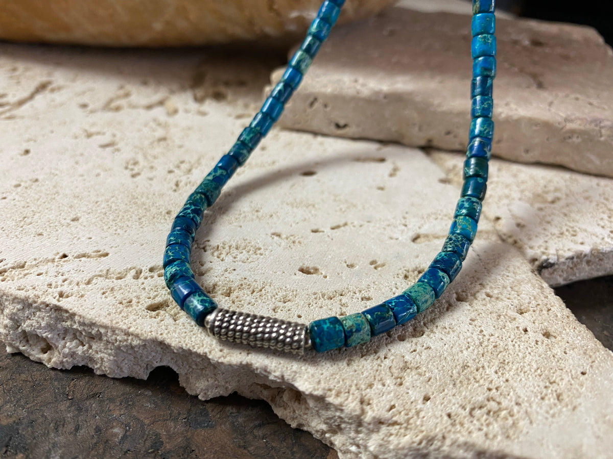 Strong blue green necklace crafted from natural blue jasper, with a heavy vintage silver bead as a centrepiece. Finished with sterling silver ends.  This is a unisex necklace that would look great on a guy or a woman. Length 46 cm (18")