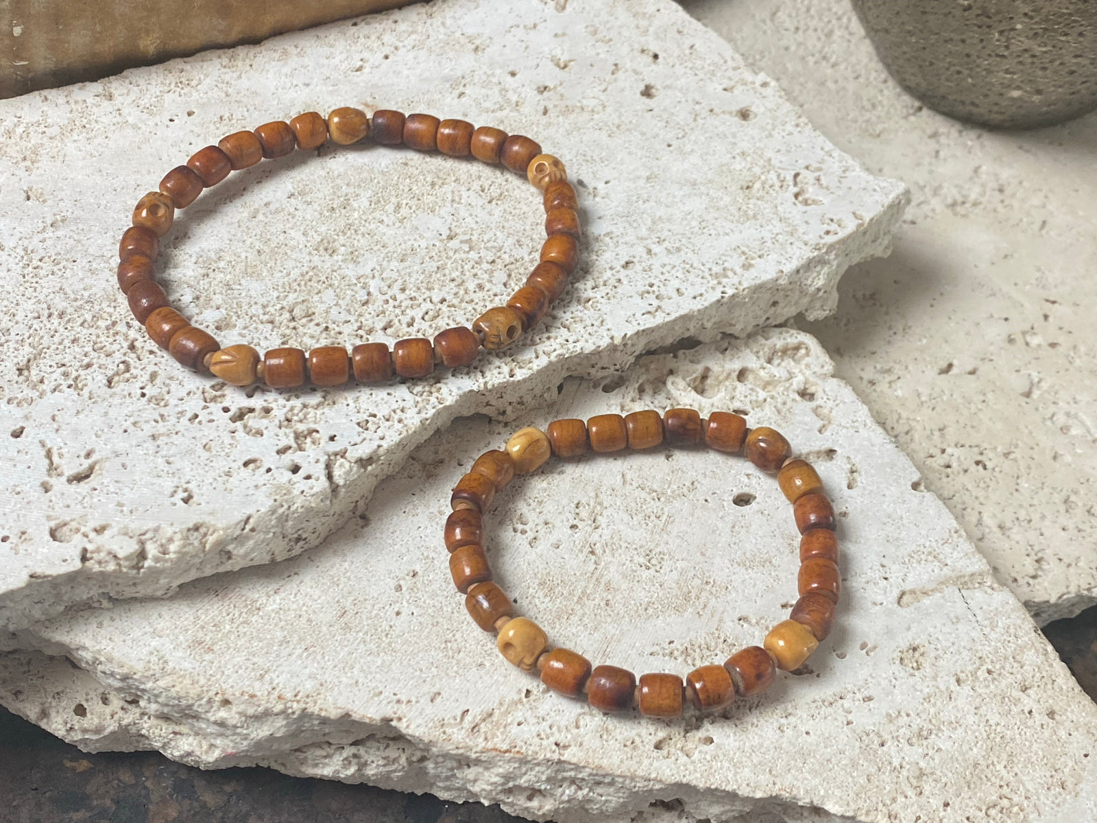 Carved vintage yak bone bead bracelet features carved skull beads and tiny sandalwood spacer beads. Unique and beautiful. Stretchy cord, wear alone or stacked with other bracelets for a classic boho look. Two sizes, 20 cm and 18 cm. Unisex jewellery for men or women.