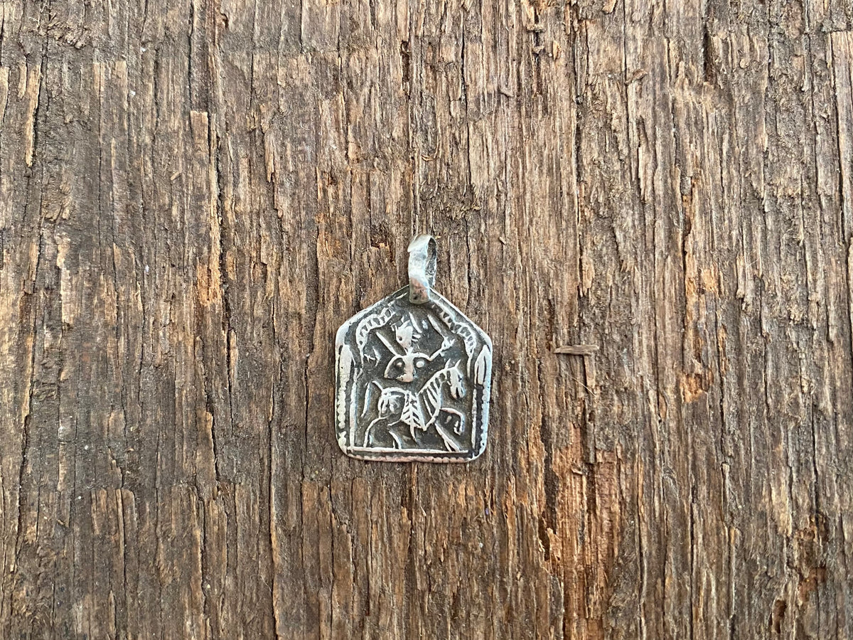 Antique silver amulets that represent Baba Ramdev (Ramdevshi), a legendary Rajput warrior who went about doing deeds of goodness and valour. These small pendants are traditionally worn for protection and good luck and date from the early 19th - early 20th century.  Measurements: all vary between 1.5 and 1.7 cm in width