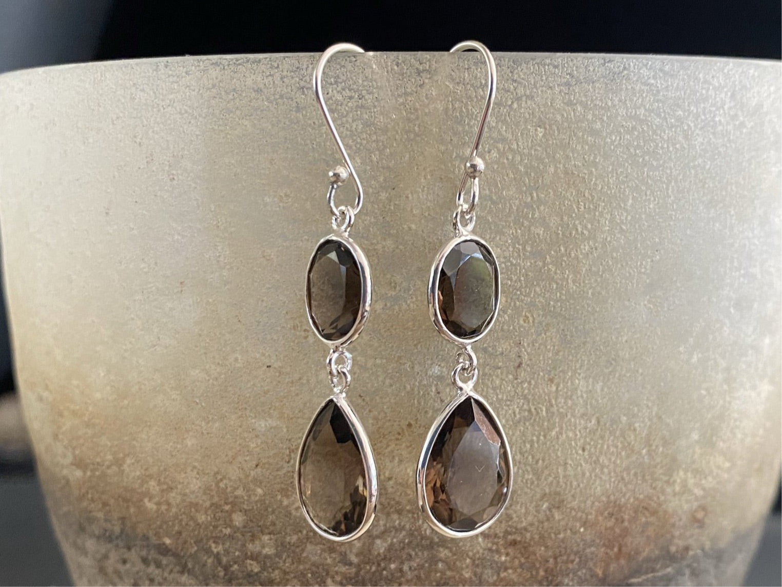 Visually stunning, facet cut drop earrings of facet cut clear or smokey quartz, finished with sterling silver mounts and hooks. The perfect drop earring. Length including hook 5 cm