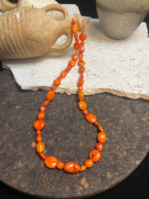 Bold and long red bamboo coral necklace featuring orange-red coral boulder beads of different sizes finished with sterling silver clasp and hook, length 66.5 cm.