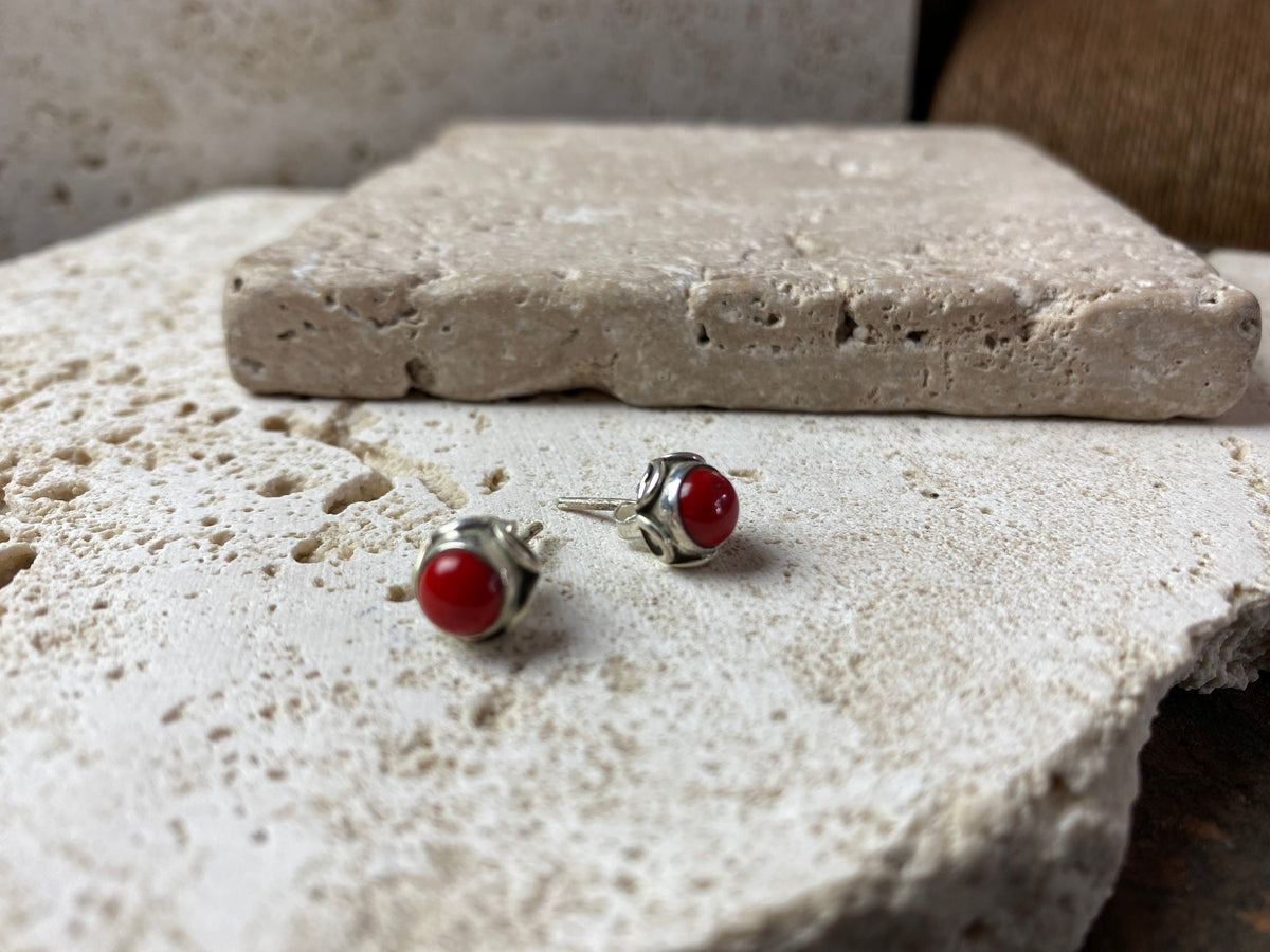large coral and silver stud earrings featuring a patterned silver bezel