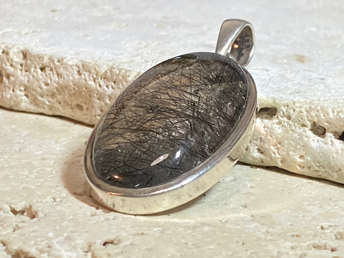 Large natural, tourmalated quartz stone pendant finished with a generous sterling silver mount and bail to emphasise its natural beauty. This is a stunning pendant that is a little out of the ordinary.