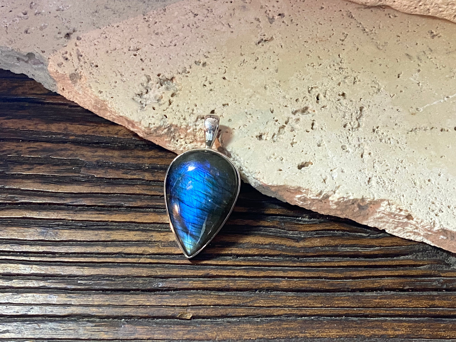 Stunning upside-down teardrop labradorite pendant set in sterling silver with a generous bail to take a large chain or cord. A stunning, high quality stone with excellent blue colour and fire.