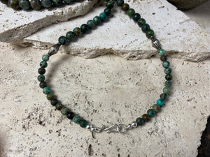 Long blue green necklace crafted from graduated round natural African turquoise, highlighted with vintage sterling silver beads and sterling silver ends. Length 67 cm