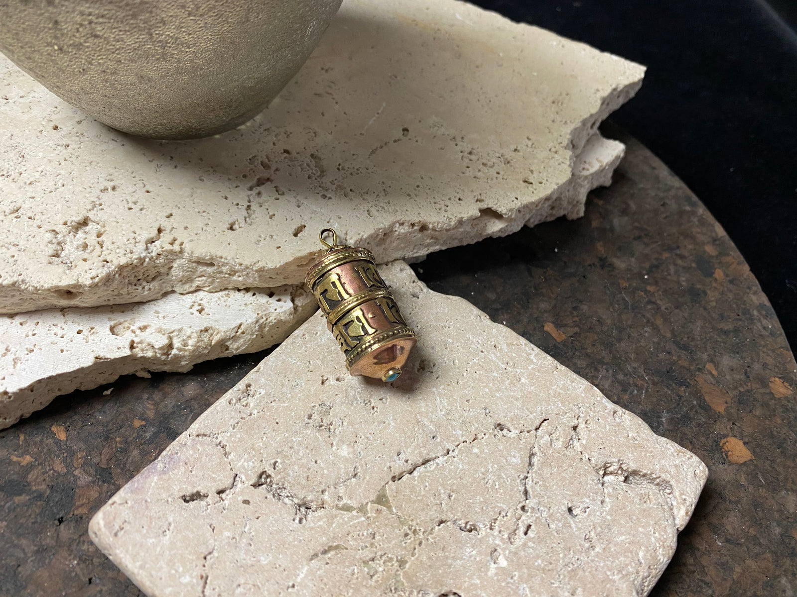 These copper and brass prayer boxes or amulets are designed to be worn as a pendant, or added to a keyring. Contains a prayer scroll withthe mantra to the Compassionate Buddha Om Mani Padme Hum , 4.5 cm length