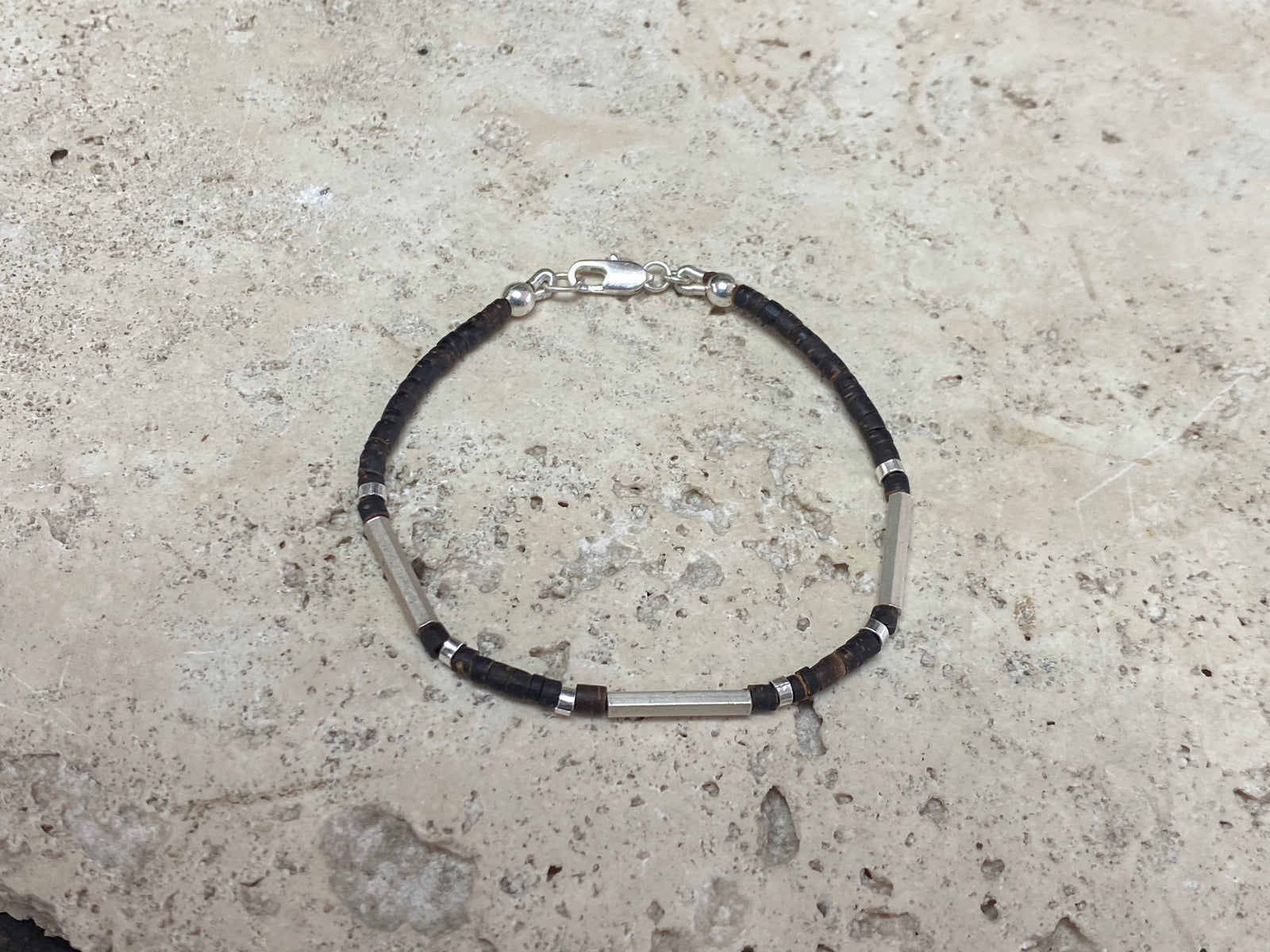 One of our signature coconut silver bracelets, crafted from polished coconut wood and hill tribe 95% silver., with sterling silver lobster clasp. A women's bracelet or a men's bracelet, it has a casual Boho vibe, and is made for that stacked bracelet look. Different sizes available