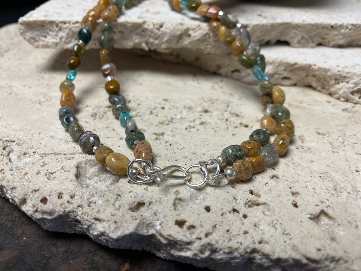A casual beach vibe necklace made from two strands of polished pebble ocean jasper, highlighted with clear blue apatite and sterling silver. Our necklace is finished with a sterling silver hook clasp and findings and is 49 cm in length