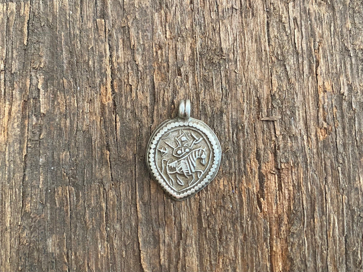 Antique silver amulets that represent Baba Ramdev (Ramdevshi), a legendary Rajput warrior who went about doing deeds of goodness and valour. These small pendants are traditionally worn for protection and good luck and date from the early 19th - early 20th century.  Measurements: all vary between 1.5 and 1.7 cm in width