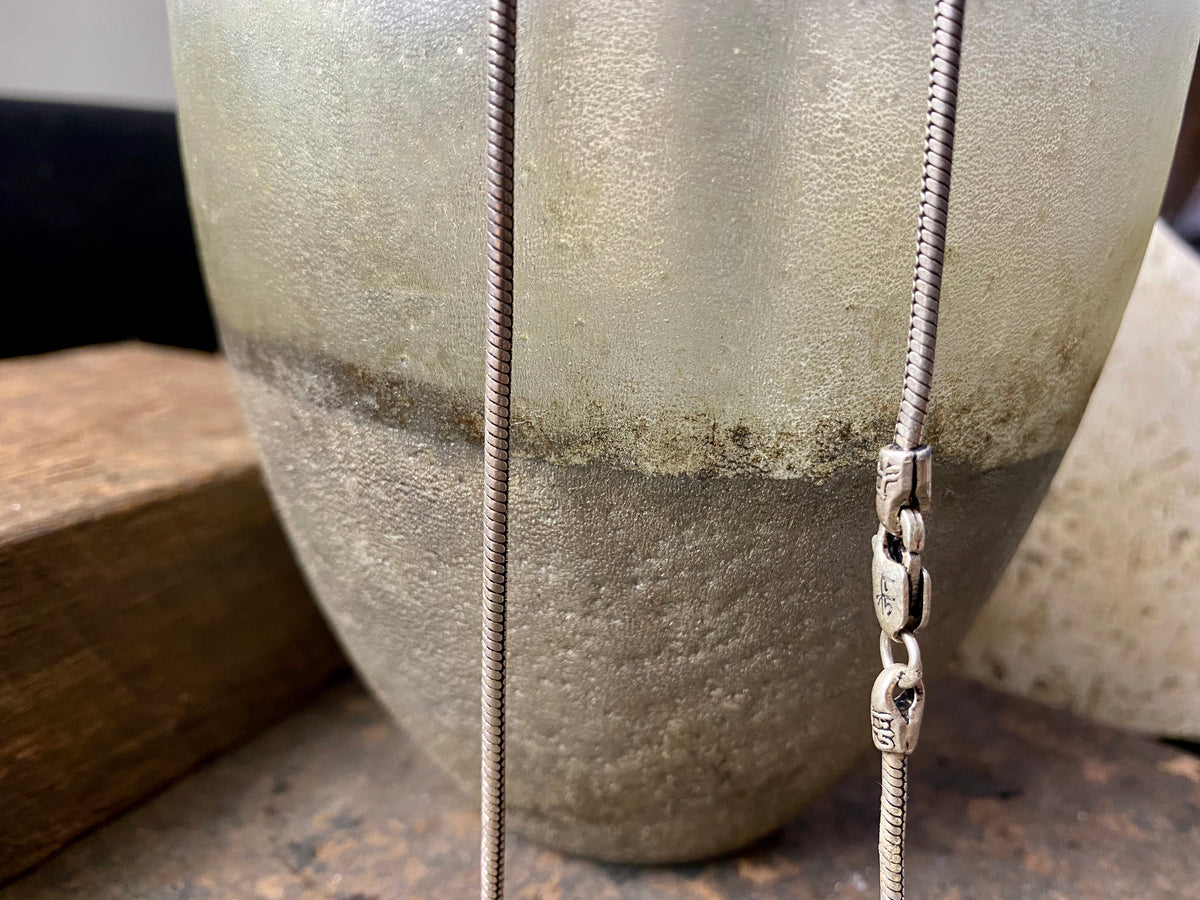 Open weave style silver snake chain, sterling silver, with a lobster claw clasp. Slightly oxidised to show the weave texture.