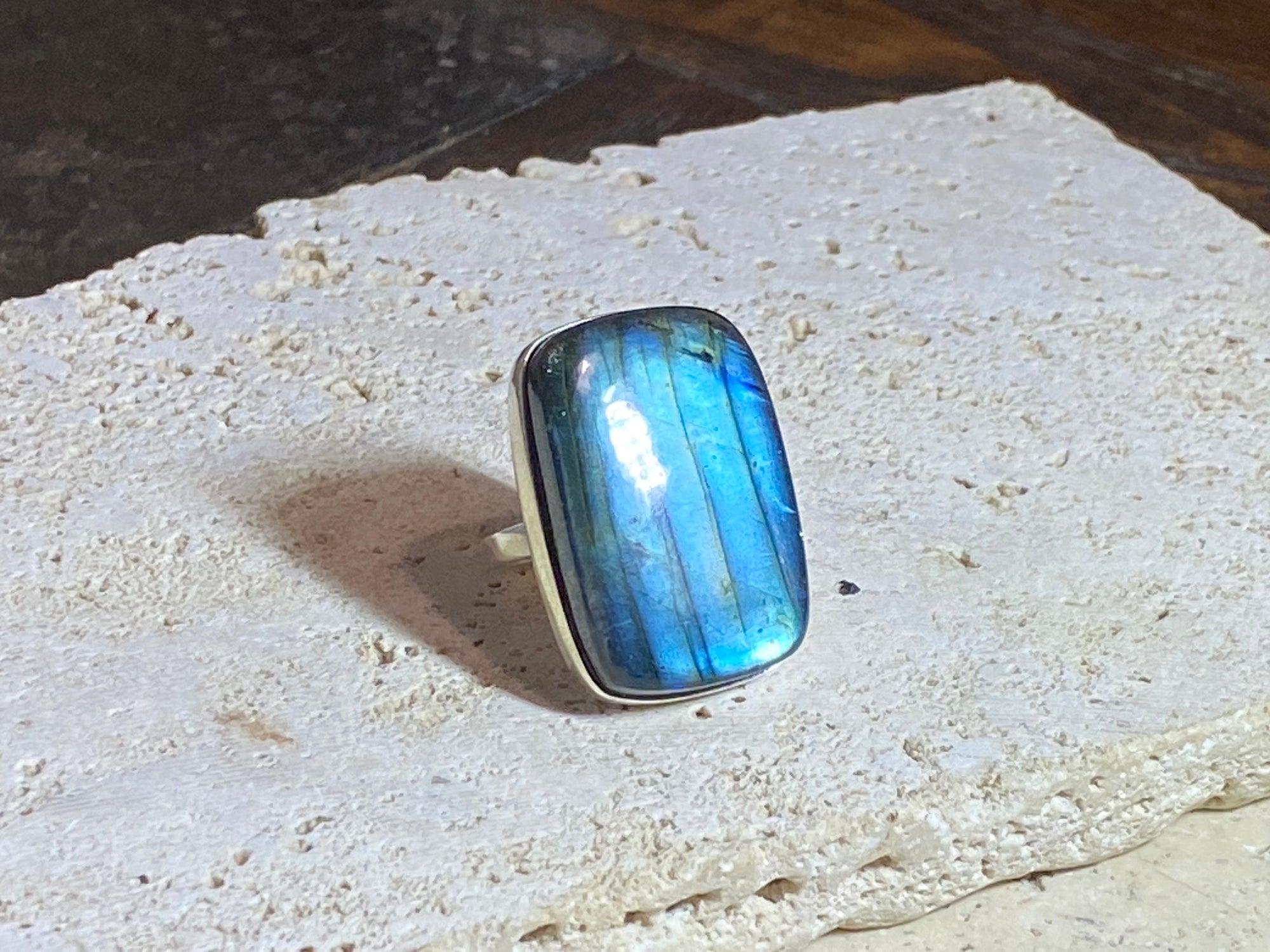Stunning large rectangular cut labradorite ring set in heavy sterling silver. A high quality stone with a unique striating pattern and excellent colour.  Size 8