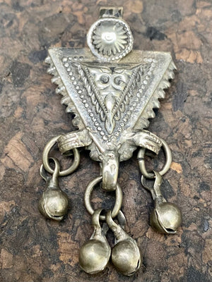 High grade silver pendant, late 19th century, Turkmenistan. It features bands of applied decorative work and a central hammered tree of life design. The pattern is repeated on both sides of the pendant. Length 6 cm