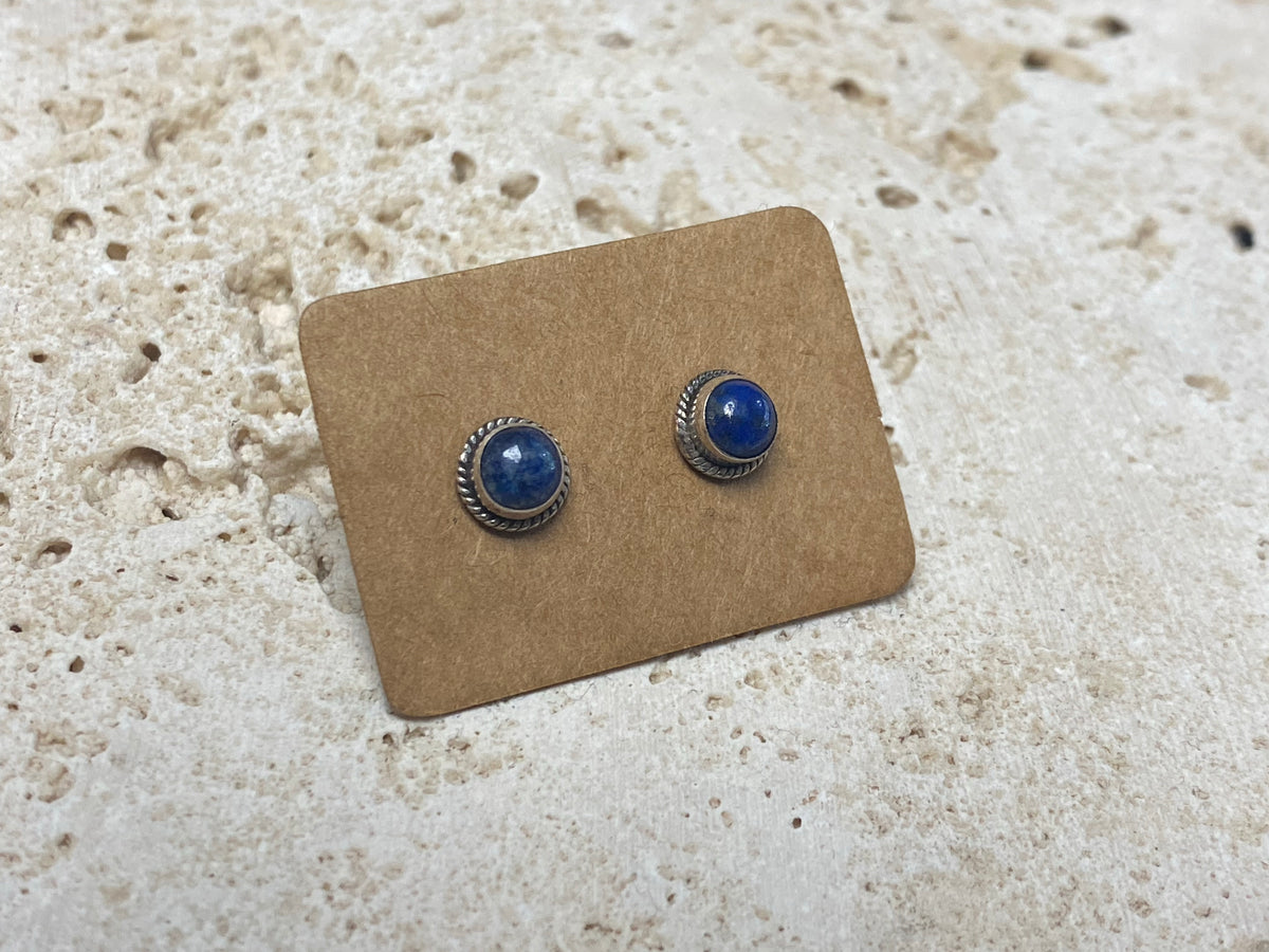 Simple and elegant, these small lapis lazuli earring studs are hand made from sterling silver and set with lapis cabochons