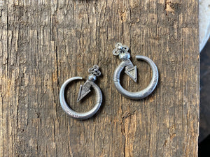 Small pair of tribal silver earrings called Bent Arrow. Worn pushed sideways through the ear by Yao women. High grade silver, they can only be worn with an extended piercing
