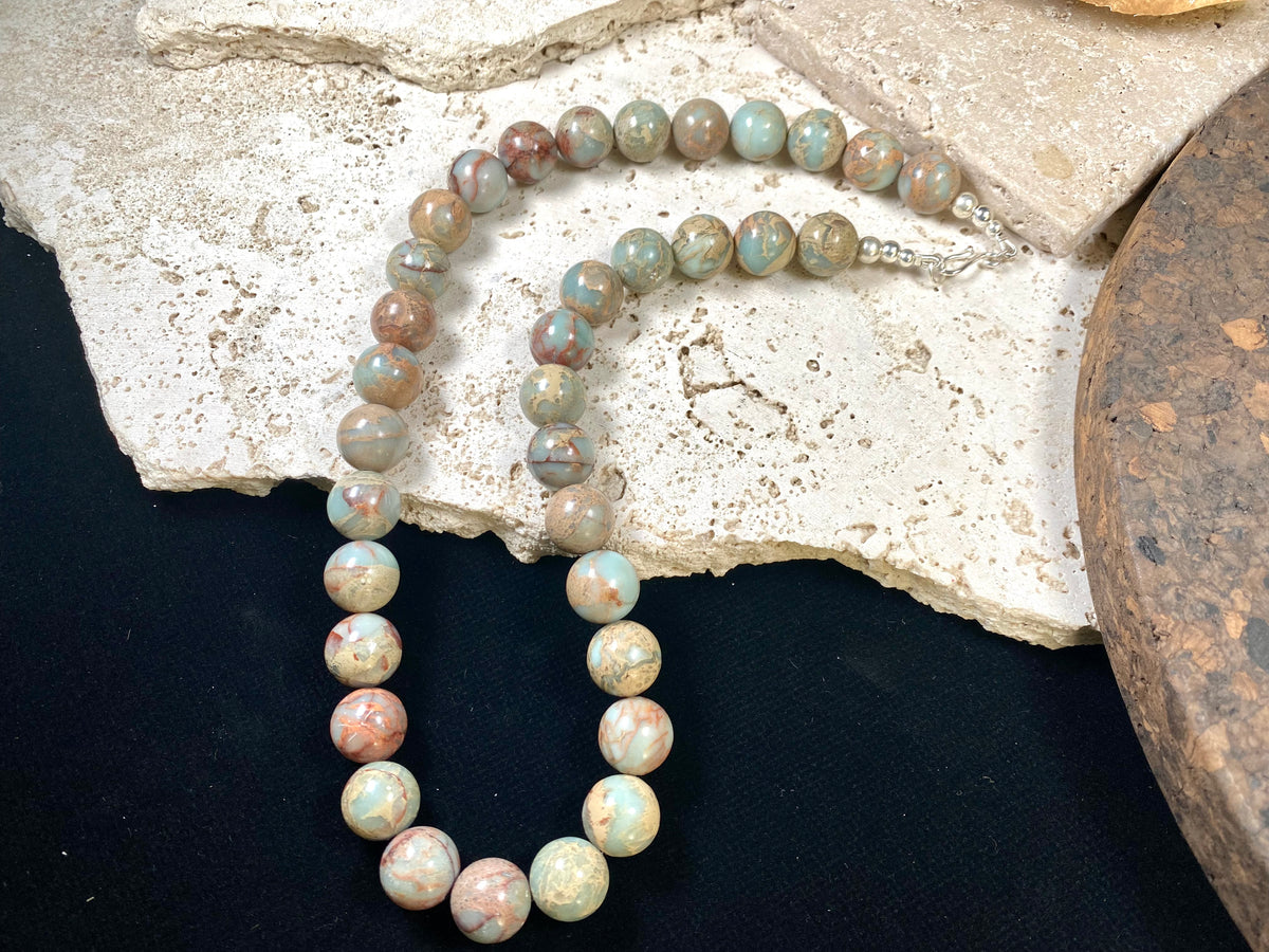 A mid length necklace made from large matched round Ethiopian opal beads, finished with sterling silver findings. Hook clasp. Length 55 cm