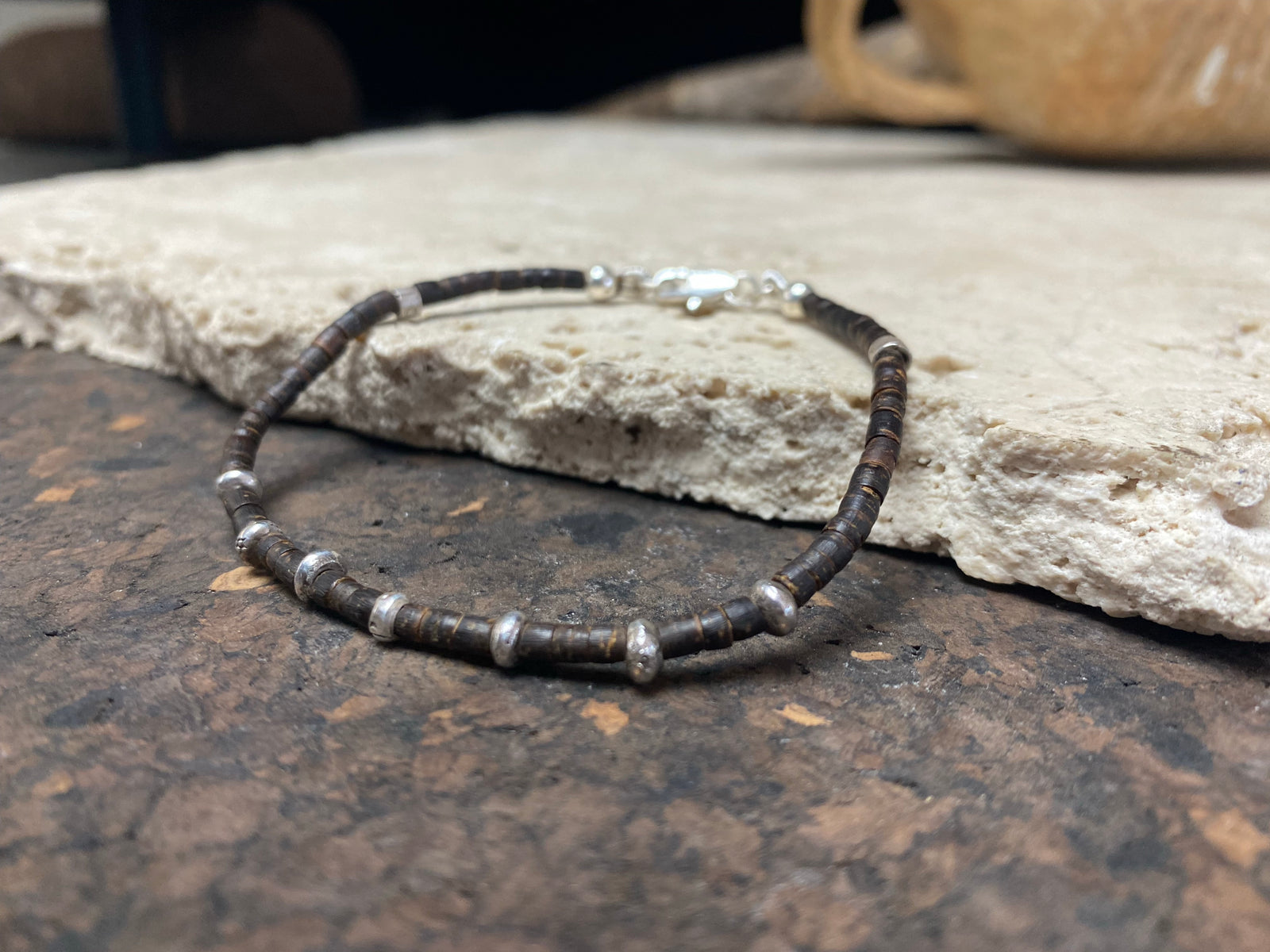 One of our signature coconut silver bracelets, crafted from polished coconut wood and hill tribe 95% silver., with sterling silver lobster clasp. A women's bracelet or a men's bracelet, it has a casual Boho vibe, and is made for that stacked bracelet look. Different sizes available