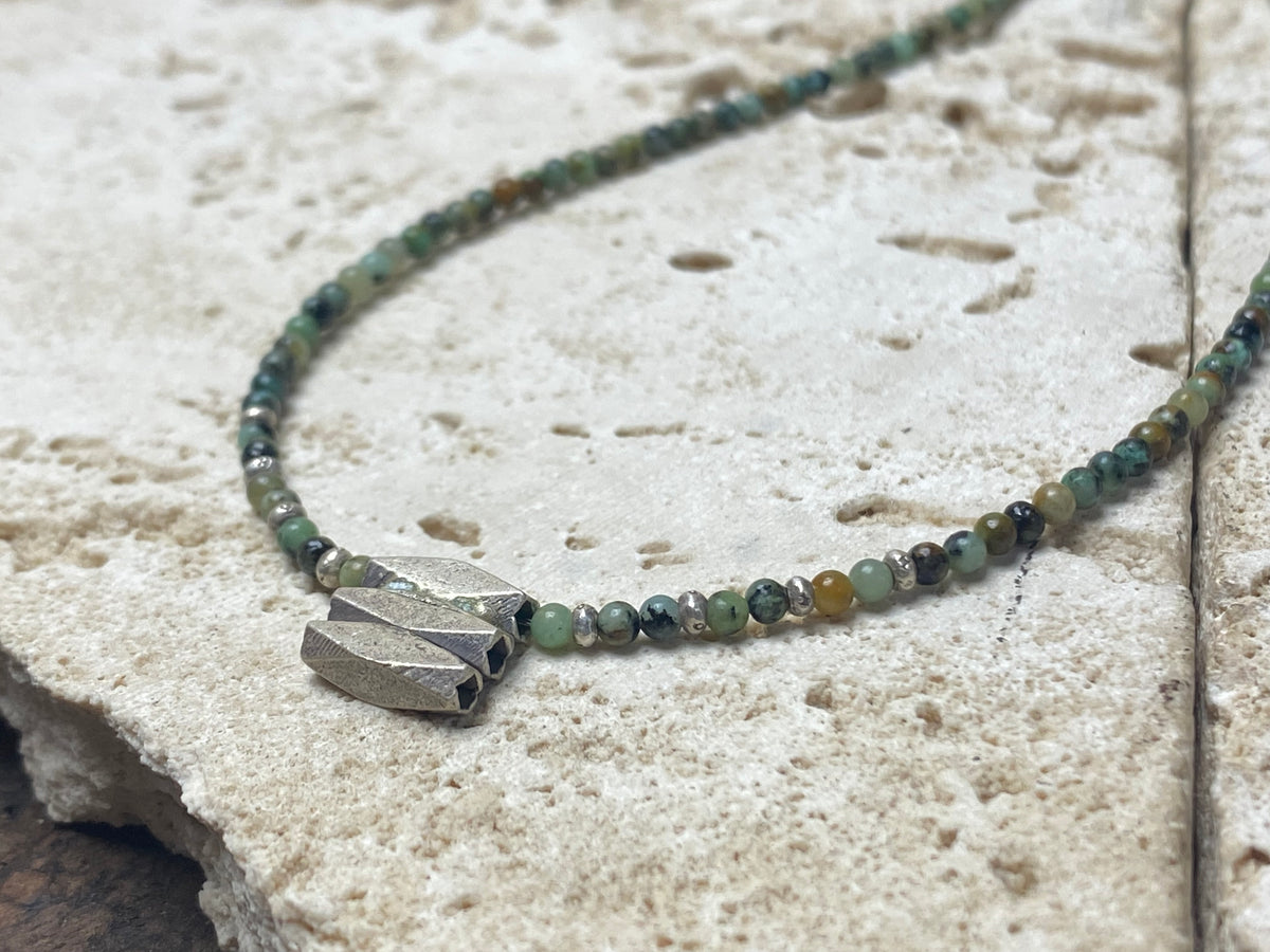 Very fine stone women or mens necklace made from tiny Ethiopian opal beads, highlighted with Karen silver "eye beads" and tribal pendant. The effect is simple, understated and stunning. Finished with sterling silver findings and clasp. A unisex necklace. Length 46.5 cm (18.35")