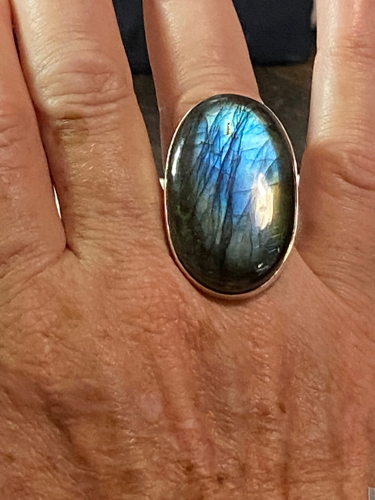 Elegant, large oval cut labradorite ring set in heavy sterling silver. A stunning, high quality stone with excellent fire - one of the best we've ever seen. . Size 7.5