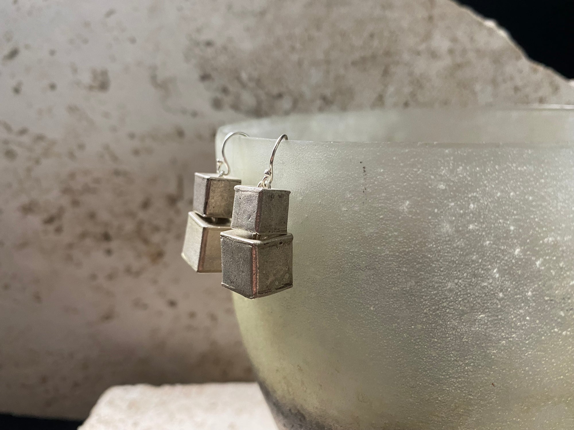 Silver earrings crafted from cubes of matted silver cleverly attached so they can move and swing independently of each other. Fascinating to look at, with a beautiful industrial effect. Length 3.5 cm