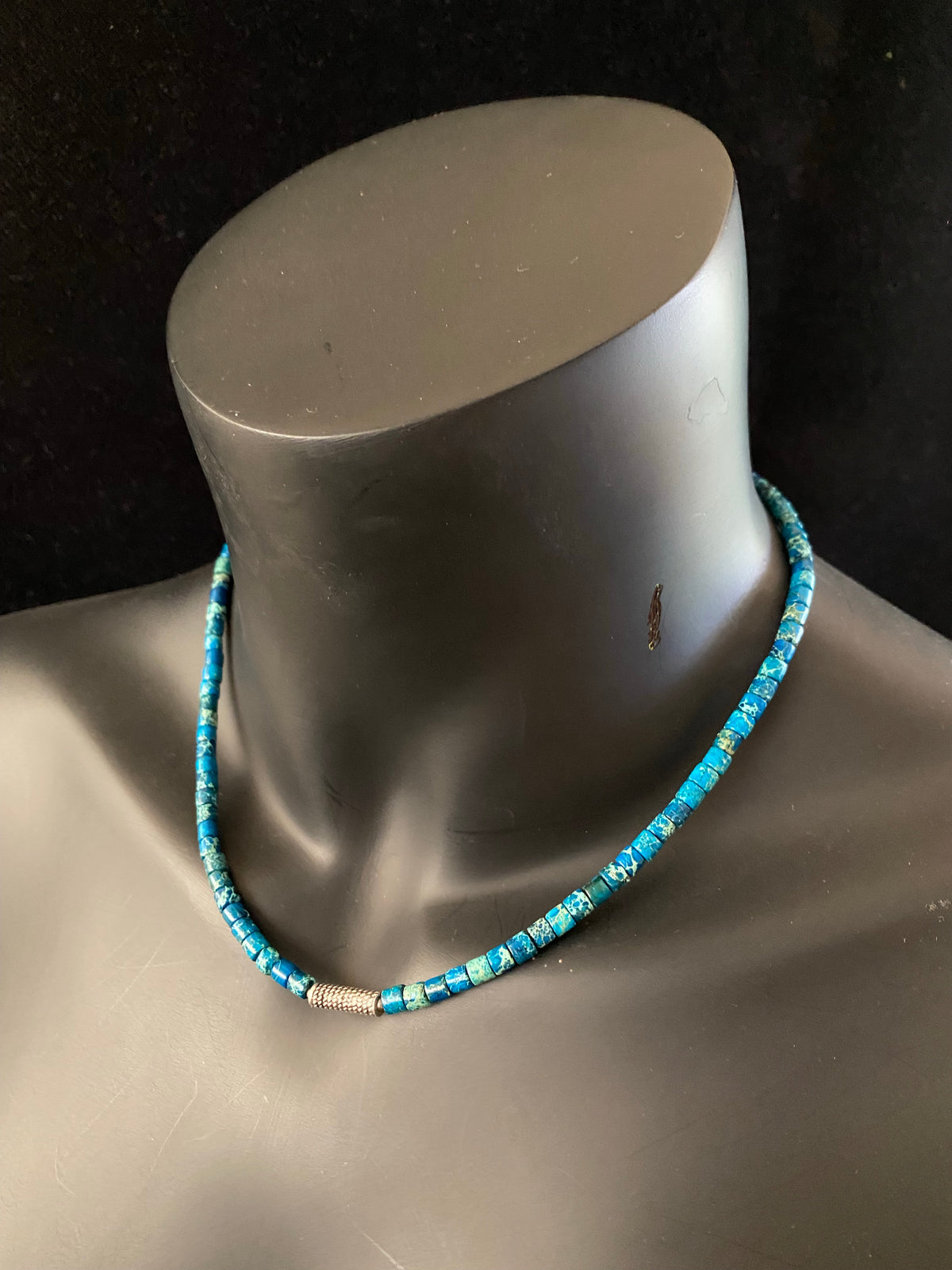 Strong blue green necklace crafted from natural blue jasper, with a heavy vintage silver bead as a centrepiece. Finished with sterling silver ends.  This is a unisex necklace that would look great on a guy or a woman. Length 46 cm (18")