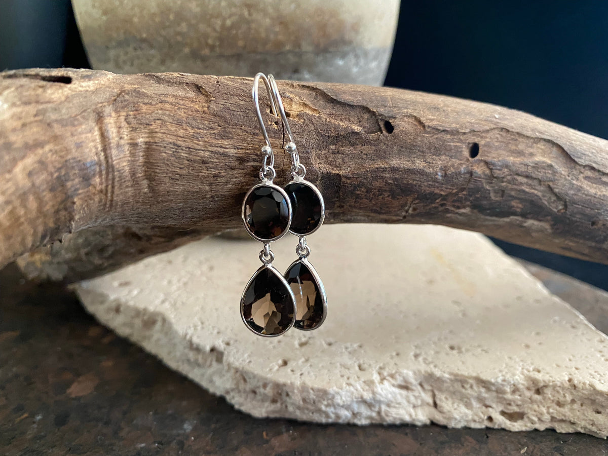 Visually stunning, facet cut drop earrings of facet cut clear or smokey quartz, finished with sterling silver mounts and hooks. The perfect drop earring. Length including hook 5 cm