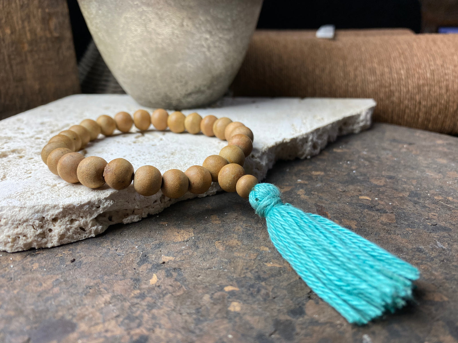 29-bead wrist mala made from genuine sandalwood beads with turquoise blue cotton tassel. On elastic. This is a large mala bracelet