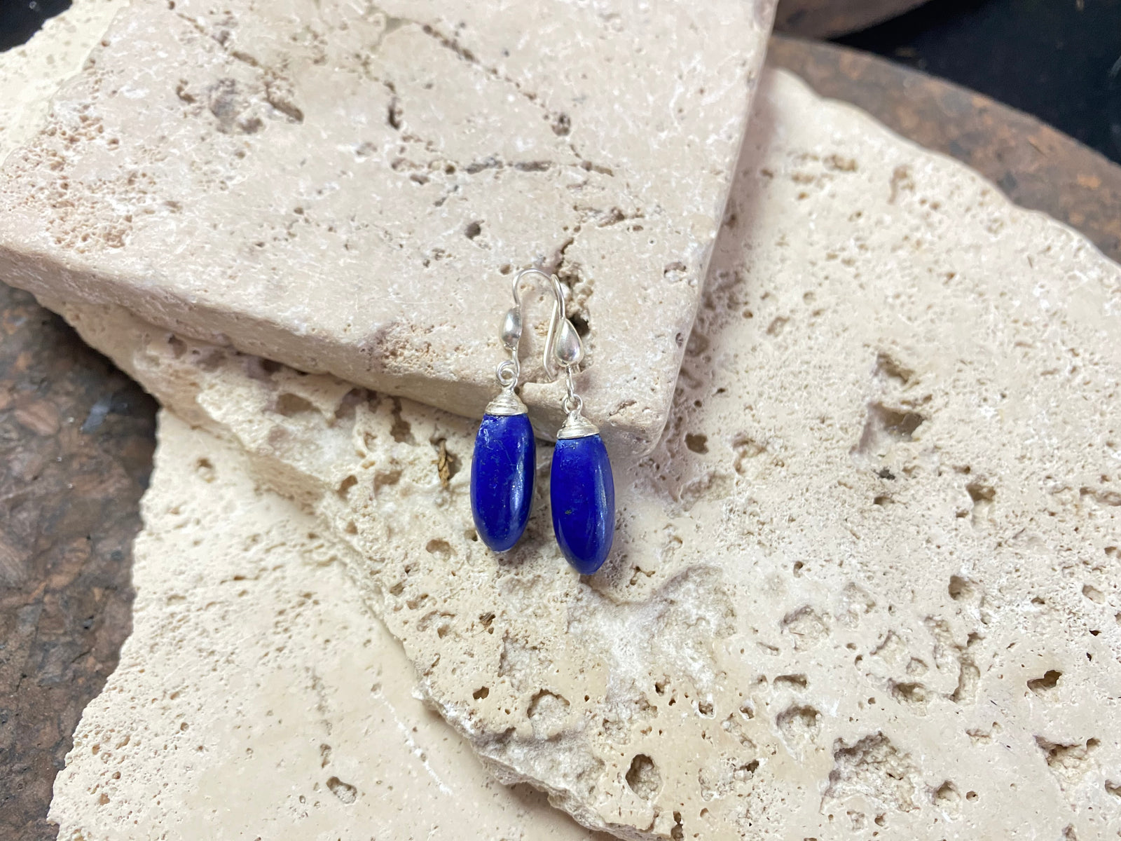 Lapis lazuli natural bead earrings with sterling silver mounts and hooks, finished with small silver beads at the base. and